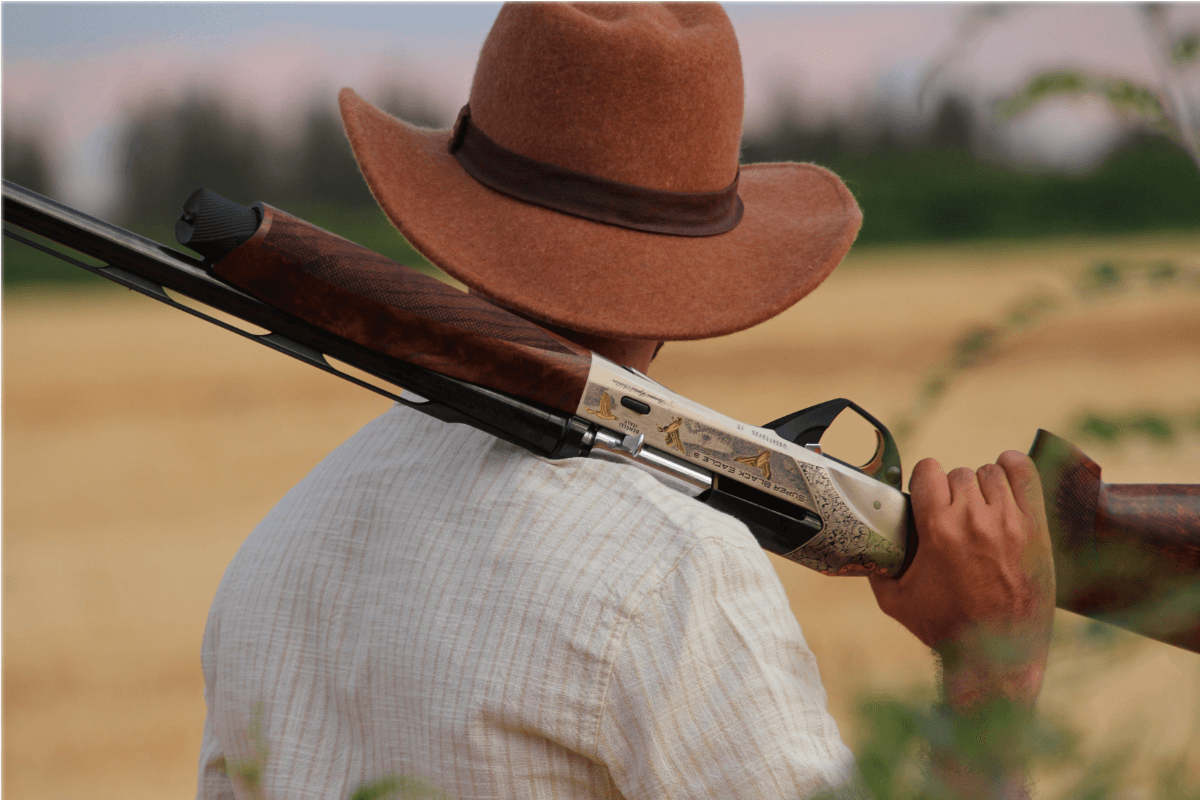 Hunter with professional guide and firearms